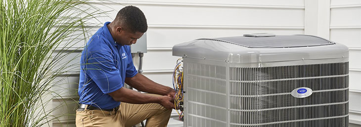 An HVAC technician ensures this New Hampshire homeowners’ air conditioning system is ready for summer weather.